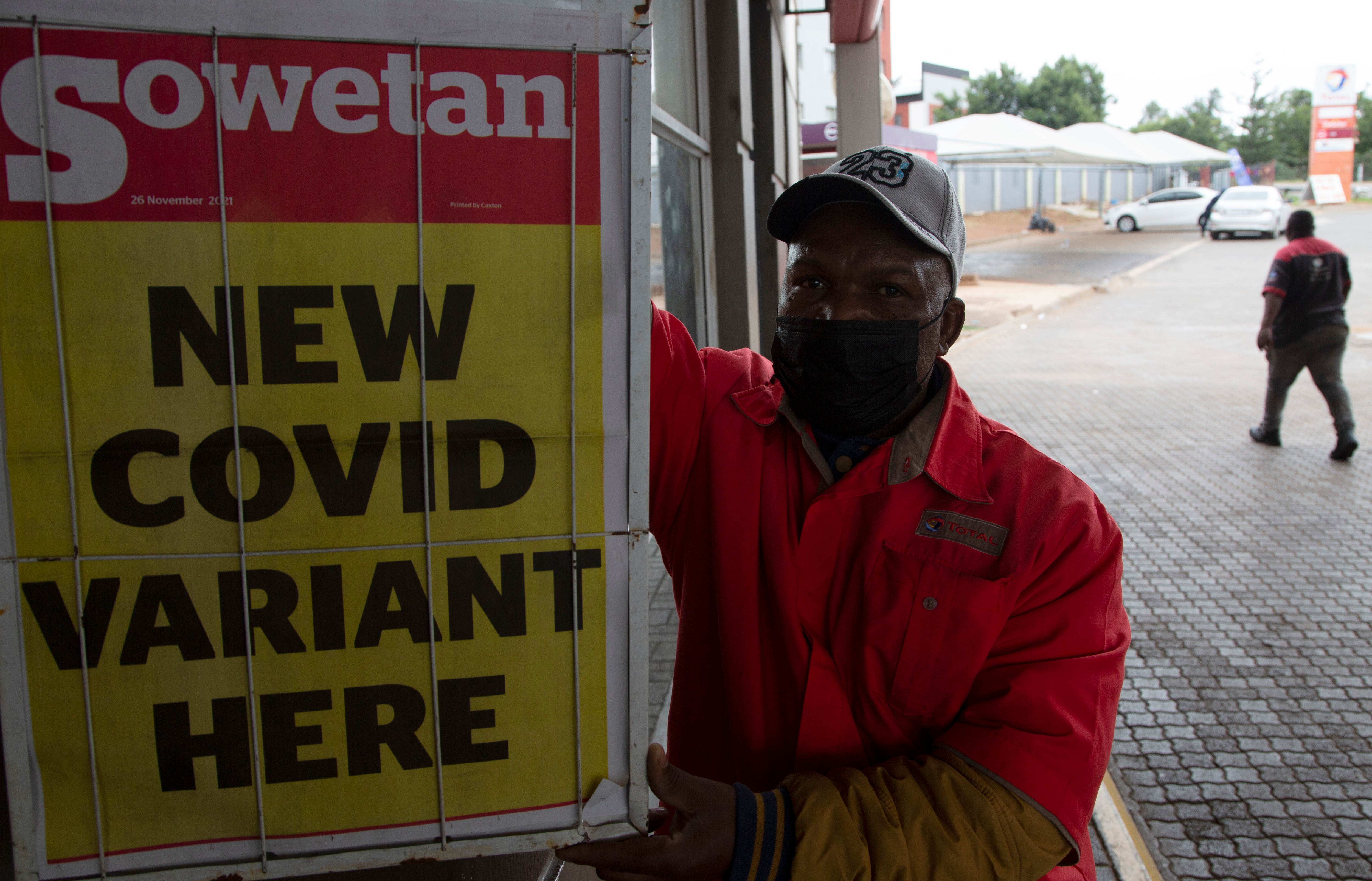 A petrol attendant uses next to a newspaper headline in Pretoria, South Africa, on Saturday, 27 November. 