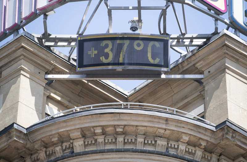 A sign shows 37 degrees at a building in the city of Stuttgart, Germany, 