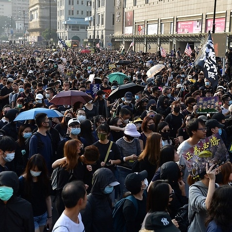 People take part in a march in Hong Kong on Sunday.