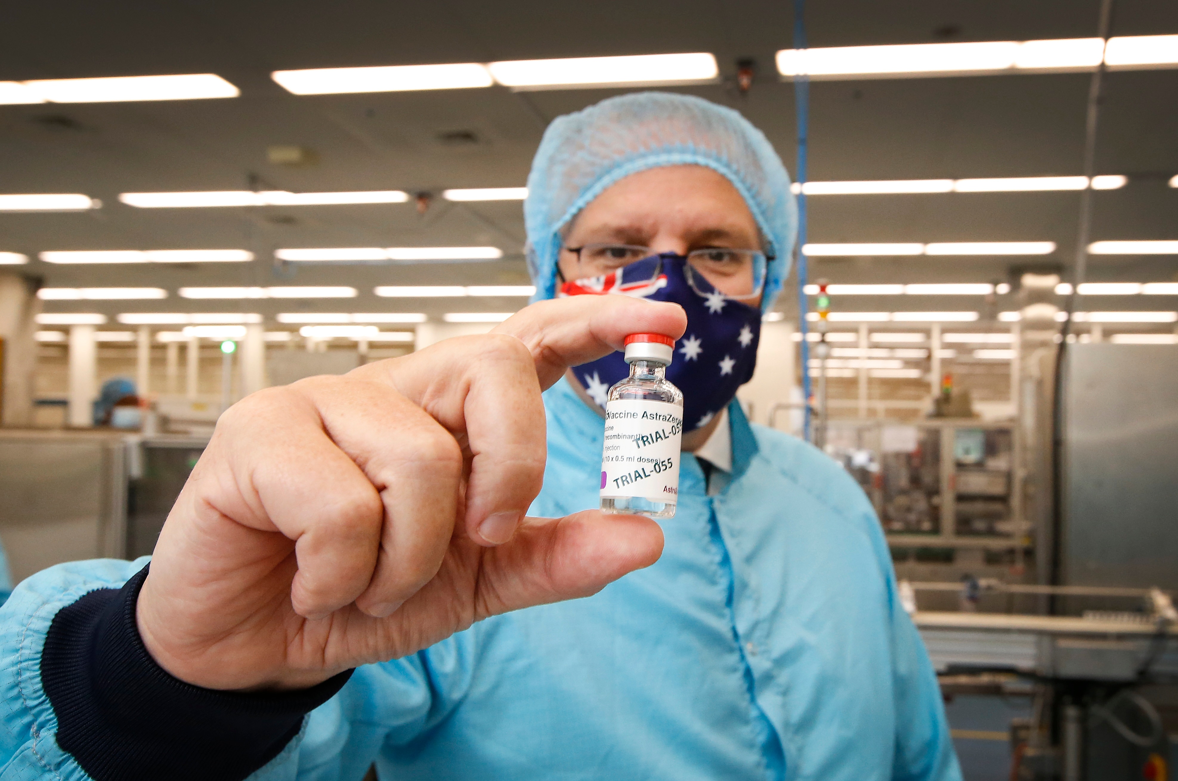 Prime Minister Scott Morrison holds a vial of AstraZeneca's coronavirus vaccine during a visit to the CSL lab in Parkville, Melbourne.