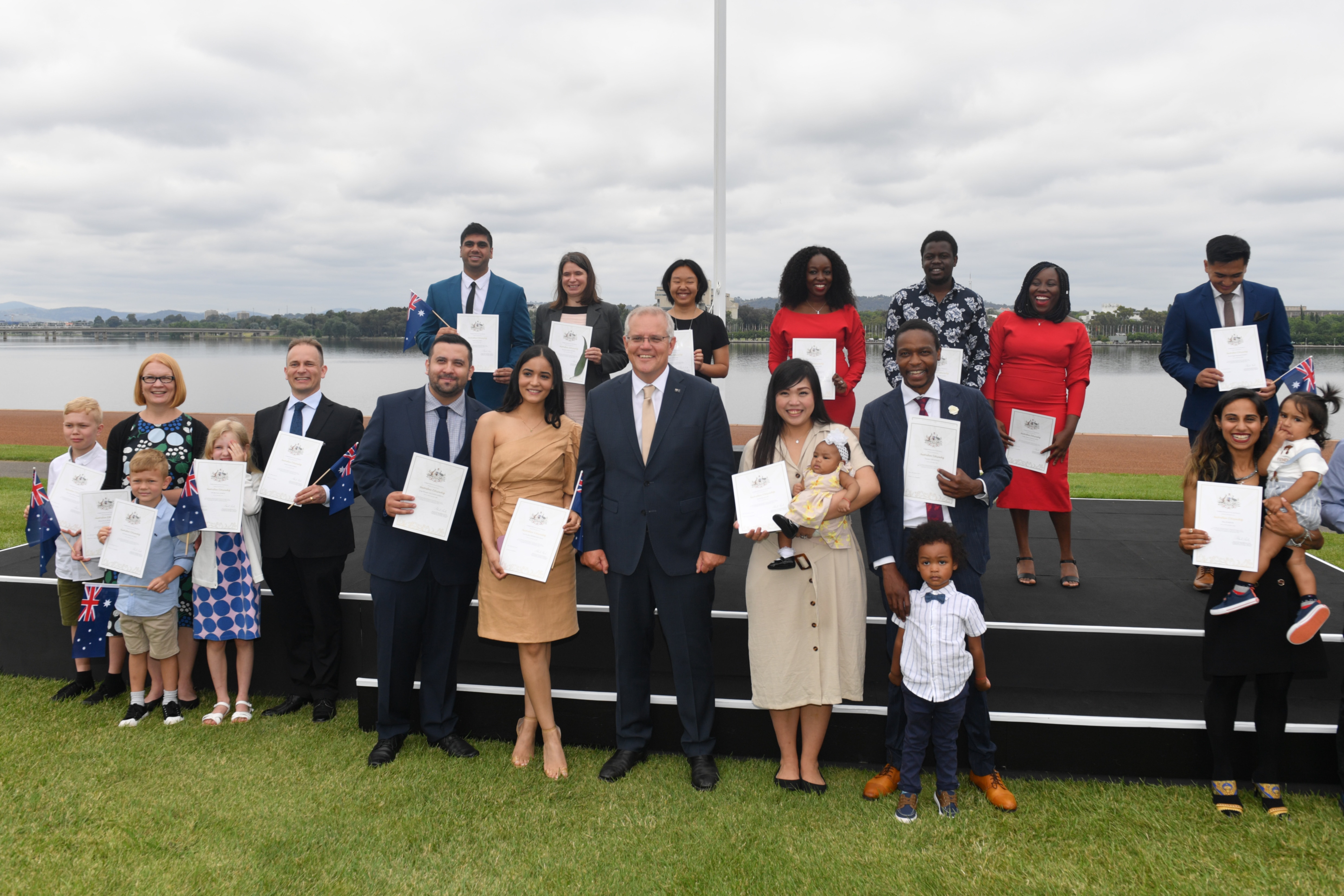 Prime Minister Scott Morrison poses with new Australian citizens during the National Australia Day Flag Raising and Citizenship Ceremony in Canberra.